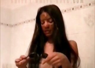 Covering her sunglasses with poop in the tub