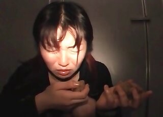 Asian model with a pierced tongue is licking her poop