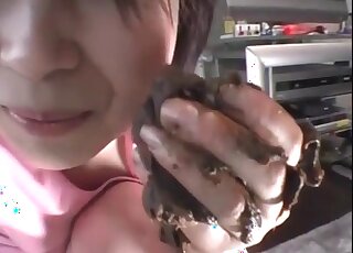 Cute Asian is smiling while eating her own poop